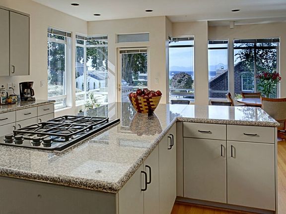 A gourmet kitchen with a view. Plenty of storage space and a nook for breakfast, lunch or dinner. Your choice! One of many decks off the kitchen.