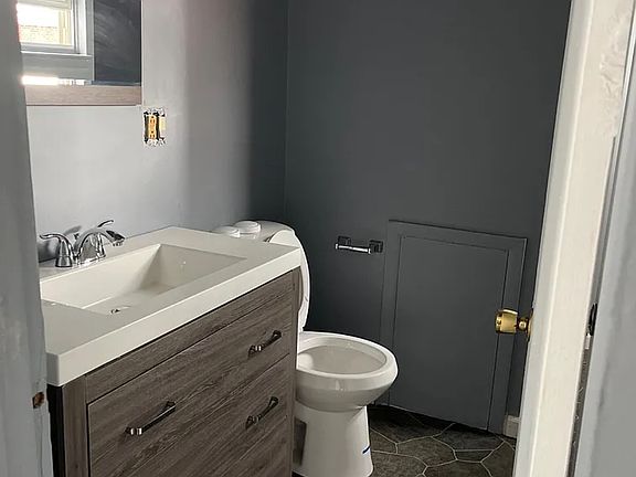 Modern spacious bathroom with stand-up shower.