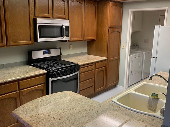 Kitchen. New stove, microwave and dishwasher. Use the old refrigerator, or bring your own. The kitchen leads to the laundry room. You can use the washer and dryer already there, or bring your own.