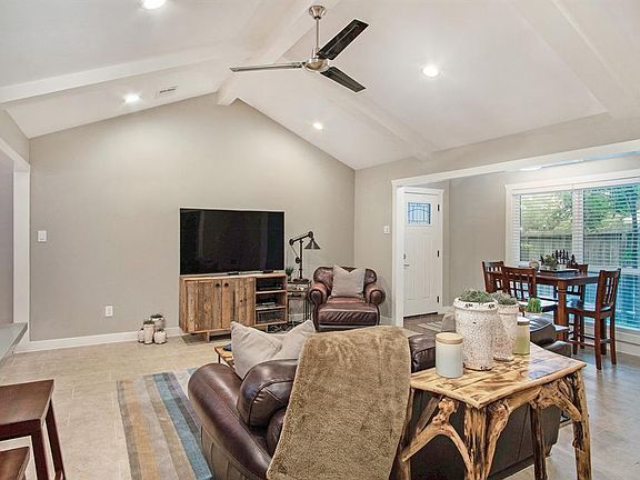 Large living area has high vaulted style ceilings with recessed lighting.