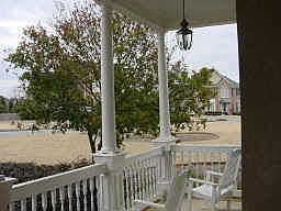 Enjoy the serene outdoor setting of your columned front porch.