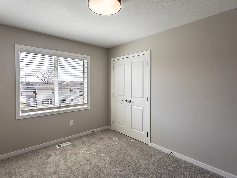 Third bedroom with french-style closet doors.