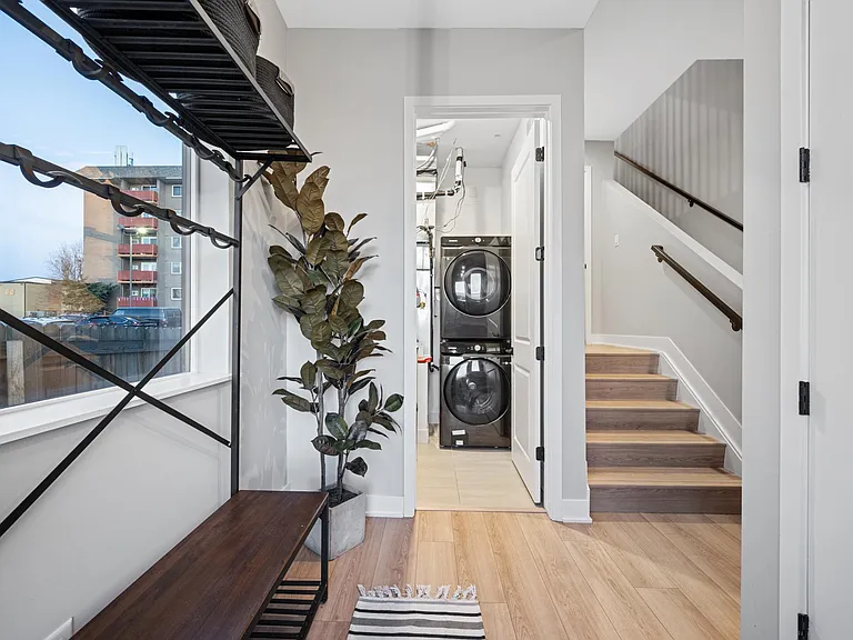This entryway acts as the best mudroom. Drop all your bags, coats, shoes, keys, & dog leashes here & keep the rest of the house clutter free! AI washer and dryer with drying rack for delicate items. There is also a half bath on this level.