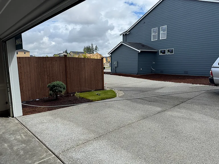 70 foot driveway, private drive. 
View looking inside 2 car garage door at the neighbors home. Drive leads to street and faces the park.