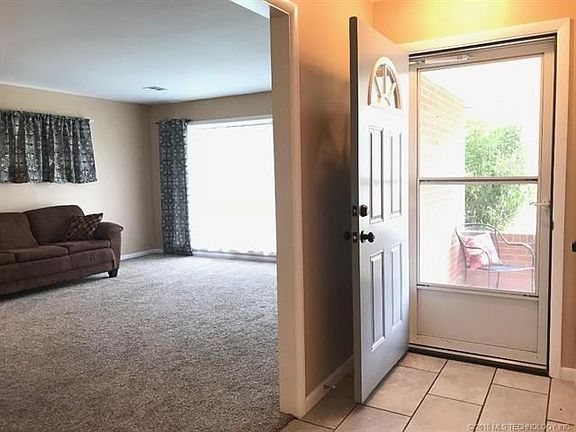 Welcome! to Tiled Foyer and Large Living Room with Large, bright, double pane windows.