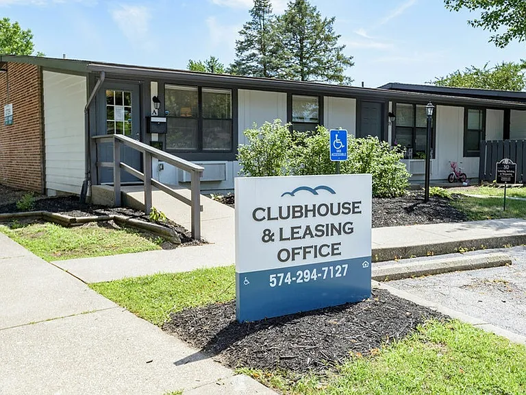 Leasing office and clubhouse sign in front of a beautifully landscaped office