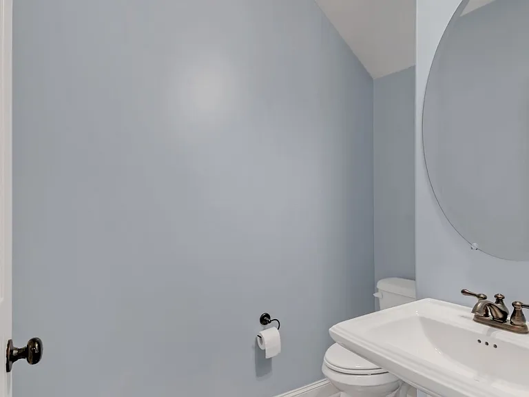 The downstairs includes a half bath under the stairs