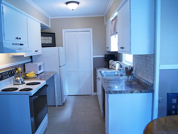 Kitchen w/new tile floor and back splash.