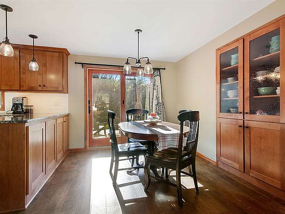 Kitchen is open to dining area with built ins and patio door over looking the serene backyard.