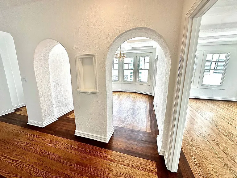 Unit #602 architectural rounded archways leading to dining room