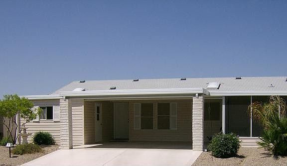 Popular St James model across from the Club House! Perfect for winter home or year long retirement home in this popular community!  A front AZ RM and a back AZ RM adds 2 extra rooms to this model!