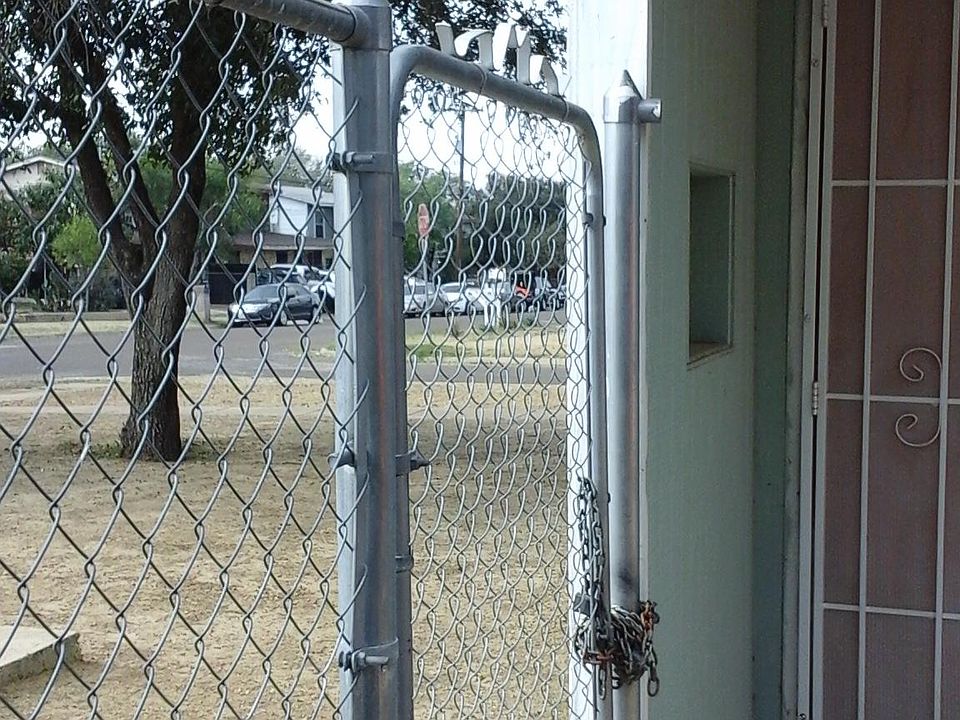 Front gate separating patio from parking area.
