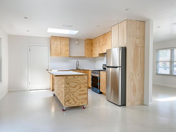 Skylit kitchen with new LG fridge, range, and dishwasher.