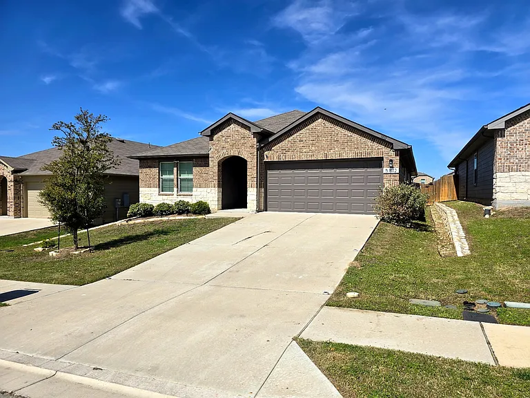 Spacious 4-bedroom home with modern curb appeal and attached 2-car garage in a quiet neighborhood.