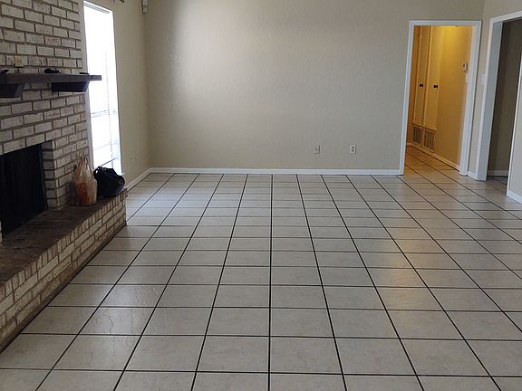 Living room with fireplace and double doors to the backyard patio