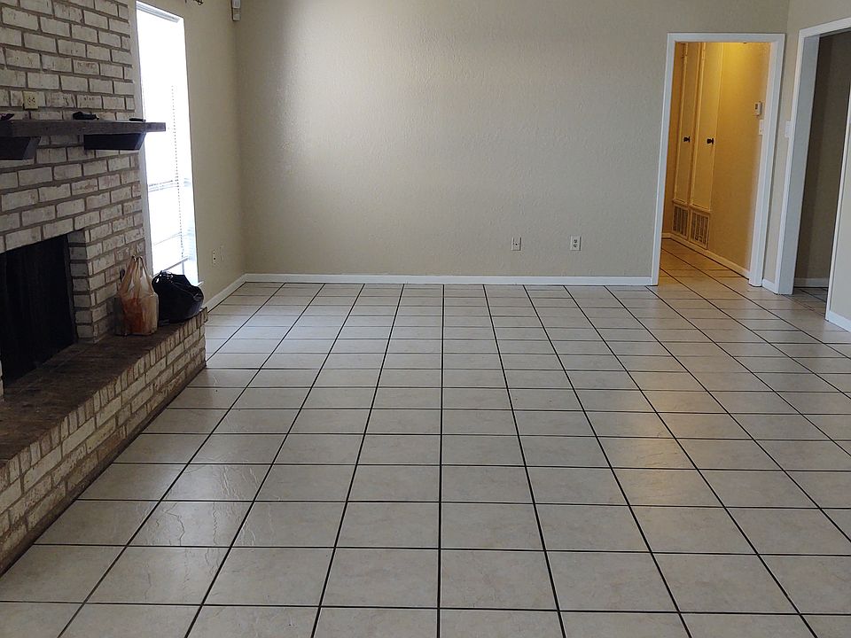 Living room with fireplace and double doors to the backyard patio