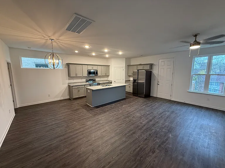 Open floor plan concept. Door leads to deck off main living area.