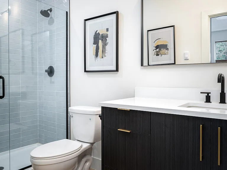 Modern finishes and quartz countertops in attached bathroom