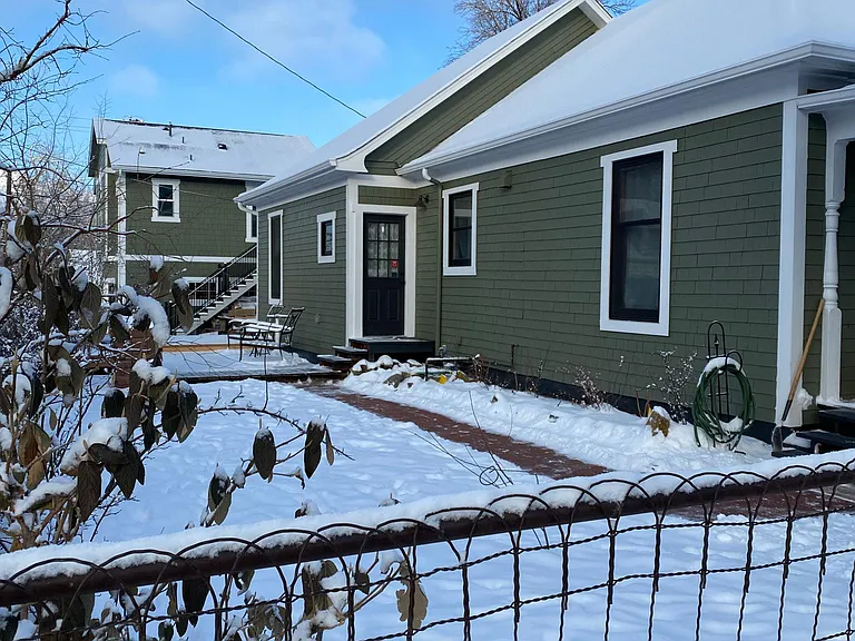 A view of the property from Franklin St. The apartment is a one story walkup behind the main house.