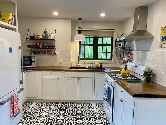 The full kitchen is newly renovated with a gas stove, garbage disposal, full refrigerator, and beautiful views!