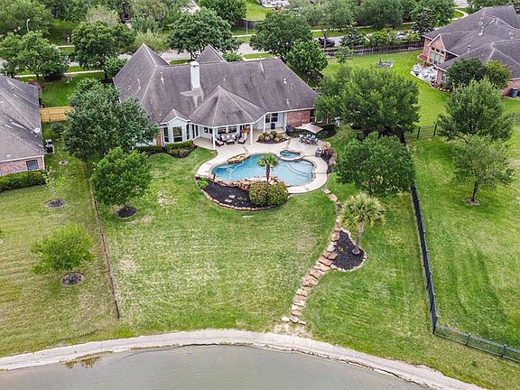 Aerial view of the back of the home showing the loevely wide lot situated in a prime location at the end of a quiet cove.