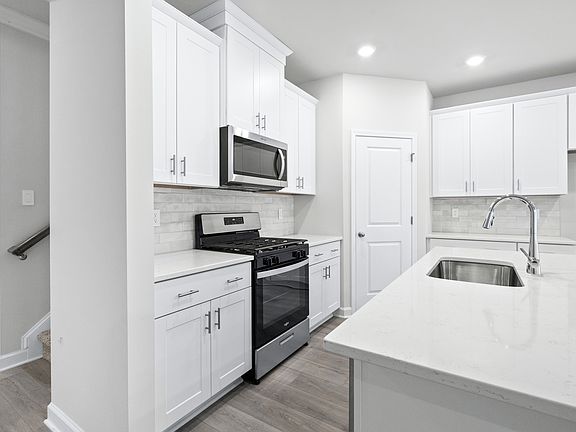 The large kitchen features stunning finishes and corner pantry.