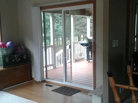 patio doors in sunroom leading to covered porch