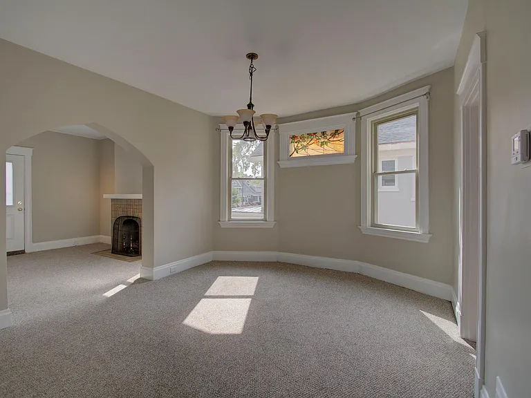 Dining room connects to large living room with fireplace