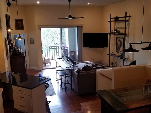 Inside main living area. 12ft ceilings (no one above you!). Sliding door out to porch over looking pond with view of Tampa skyline.