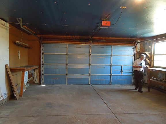 Oversized garage, new garage door and opener, work bench and storage