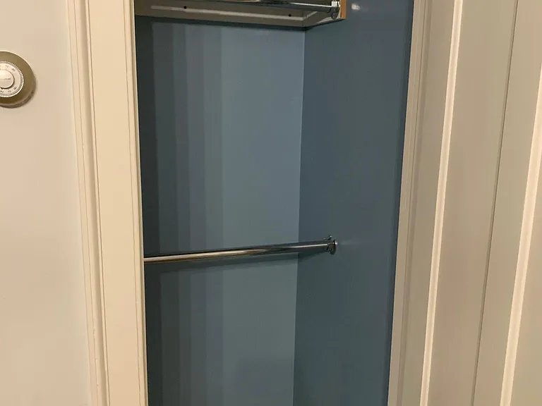 Blue suite living area closet.
