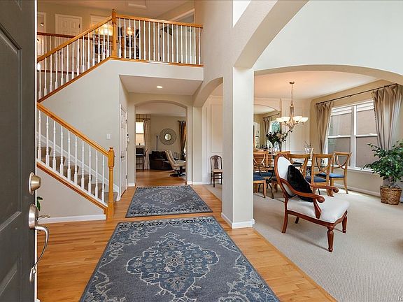 Oak Hardwood floor Entry invites you to the Den/Study and Powder Room to the left and 2 Story Living Room to the right