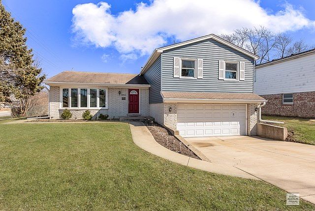 Welcoming Brick and  Newer Vinyl siding home, 2 car garage, with concrete Drive