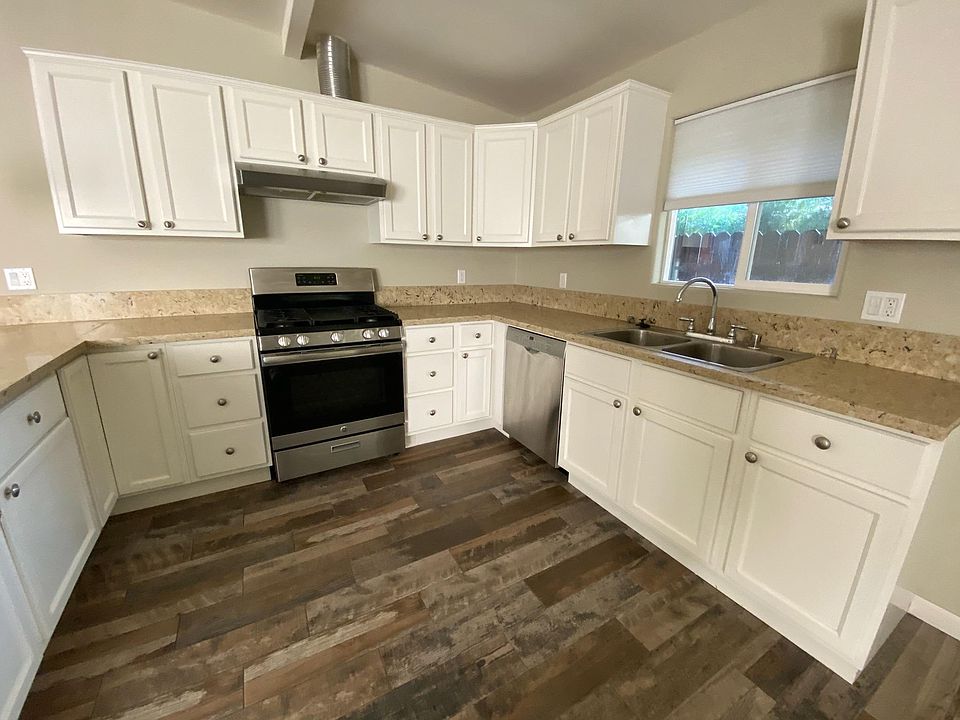Kitchen showing range, sink and dishwasher