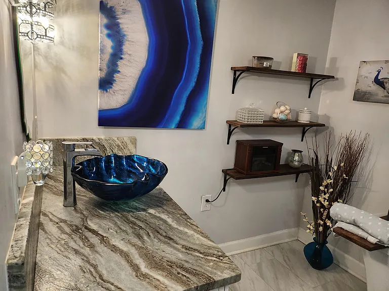 Master Bath has leathered granite vanity and sea glass sink