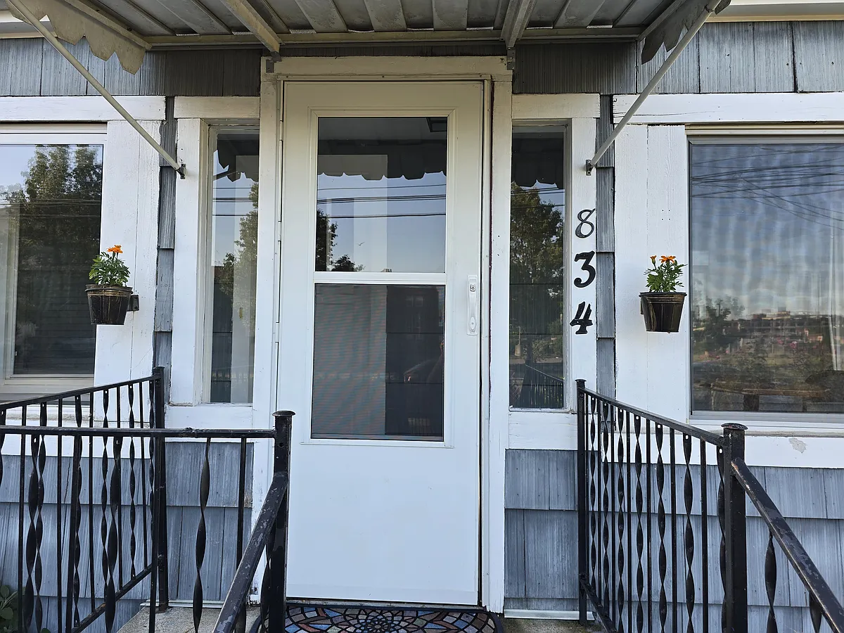 Front entrance. Storm door leading to the covered porch (mudroom). - 834 8th St