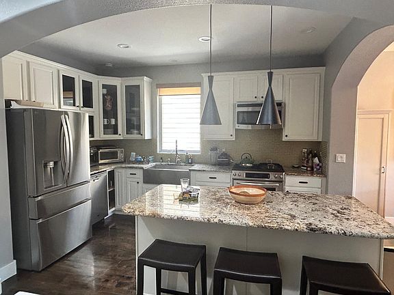 Nice open kitchen with stainless steel appliances and large island.