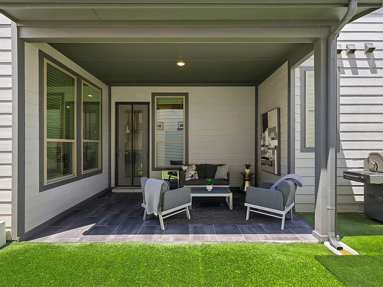 Covered patio with tile flooring, recessed lighting, and a rich dark-stained ceiling.
