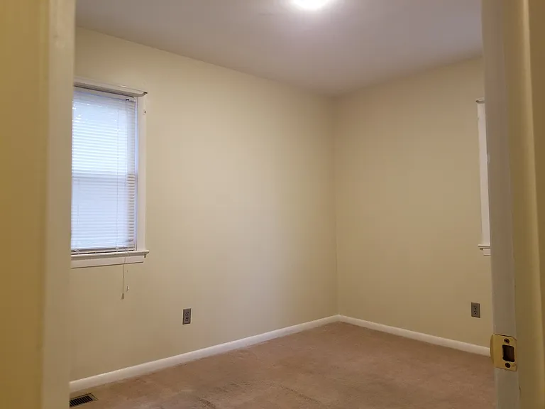 1st bedroom has 2 windows.
Window on right faces backyard.
Window on left faces neighbor.