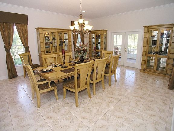 Formal Living Room with gas Fireplace and French doors leading to covered Pati