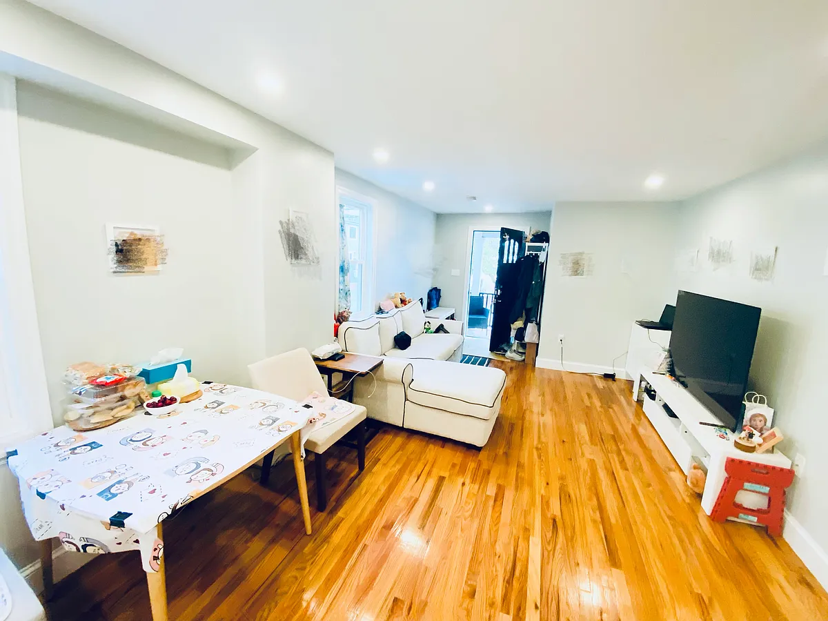 Living room with hardwood floor and two windows to get great daylight. - 8 Grant Ave #8