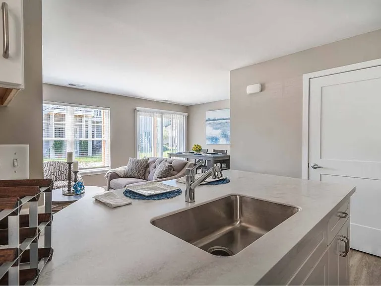 View from kitchen towards great room with living and dining areas