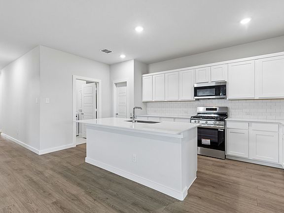Kitchen in the Oscar home plan by Trophy Signature Homes - REPRESENTATIVE PHOTO
