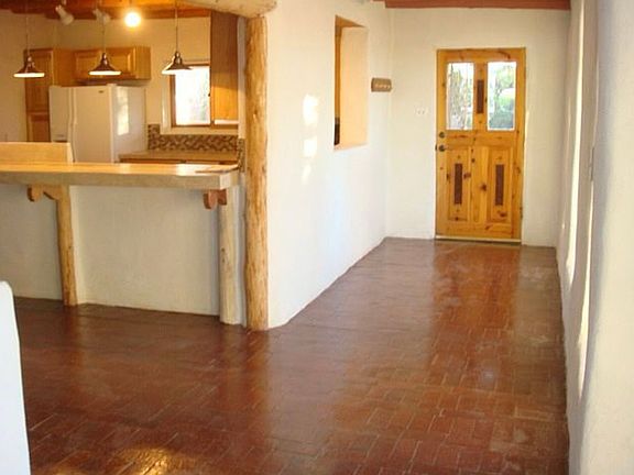 Your back door leads to a covered portal, the summer tiled soaking pond and hiking trails right out this door.