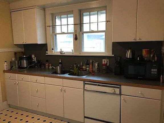 Kitchen cabinets, sink, and dishwasher.