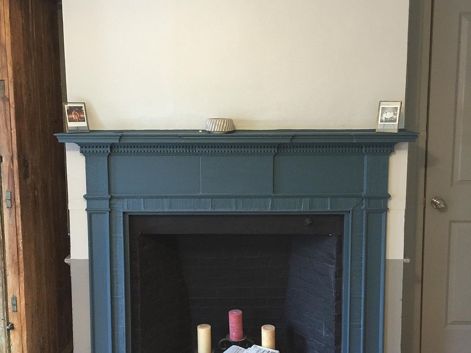 Charming decorative fireplace and mantel in bedroom