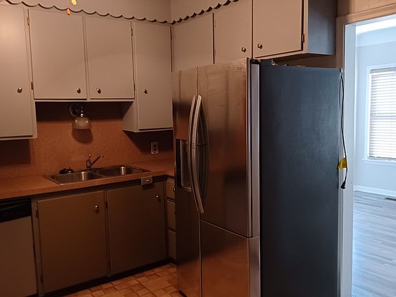 Kitchen with stainless steel refrigerator