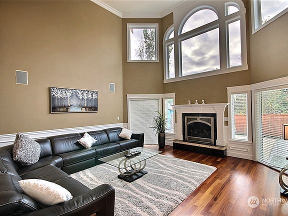 Family room with gas fireplace and high ceiling.>
