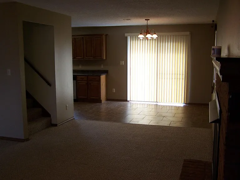 patio door, kitchen floor, stairway. Carpet is now laminate, Fireplace is now painted with new mantle.