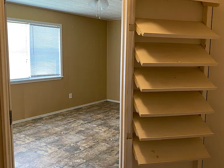 Largest walk-in closet, from the inside looking out. Shoe rack on left